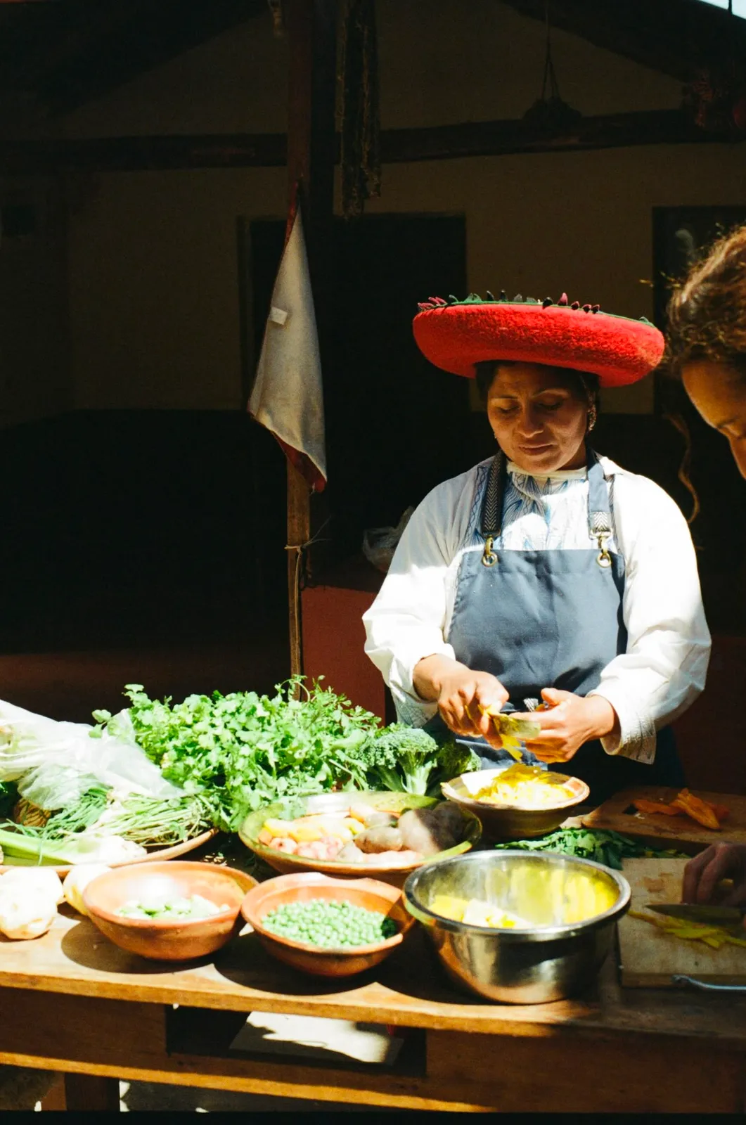 Cook in a red hat preparing vegetables for the family lunch